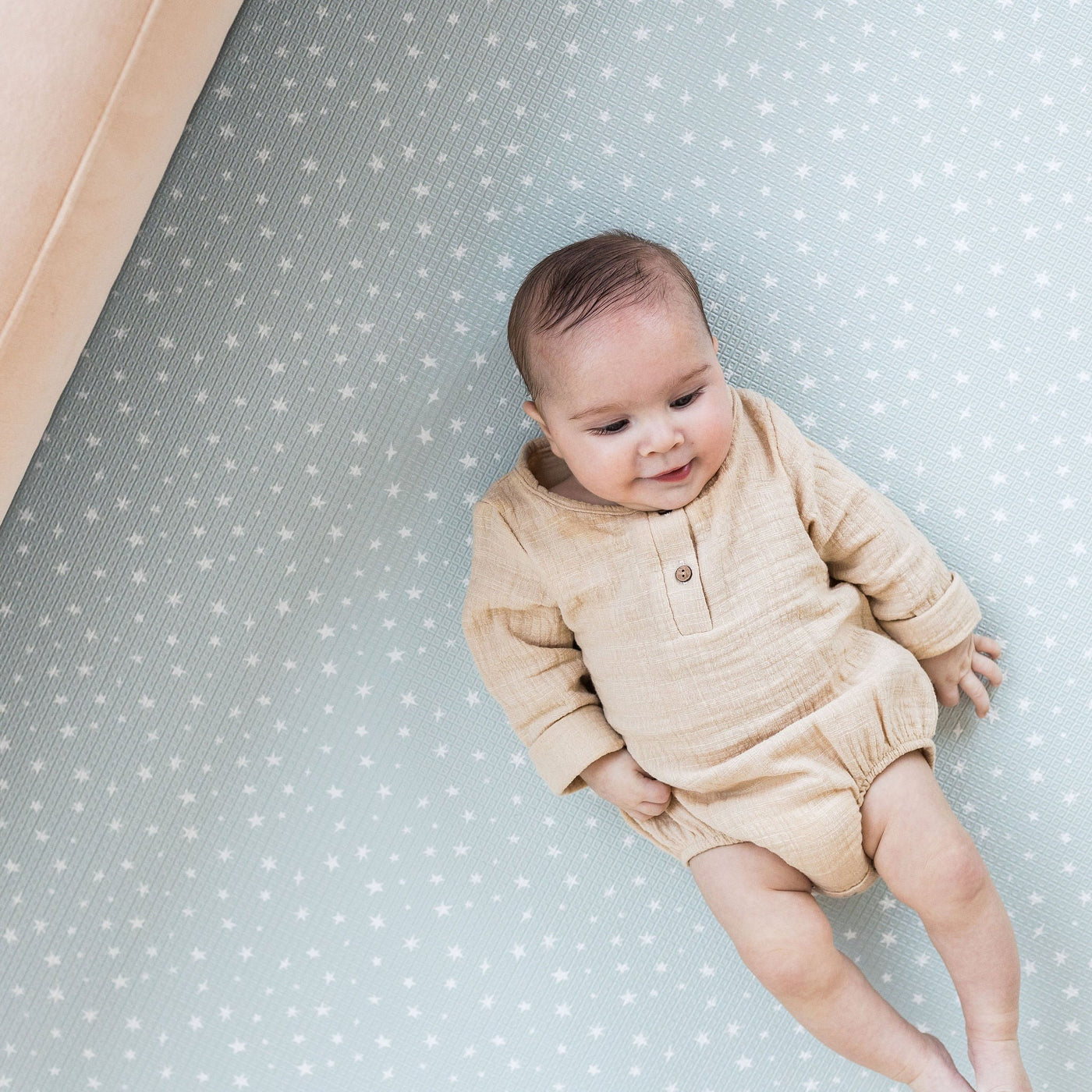 Baby on starry play mat